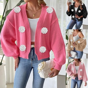 Detail of 3D crochet flower appliques on a stylish long sleeve knit cardigan sweater