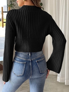 Cropped black crochet knit sweater with mock neck and bell sleeves on a model