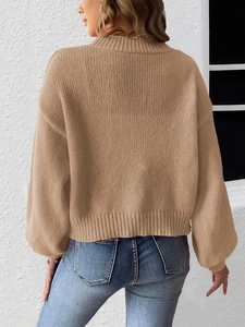 Detail view of khaki knit cardigan with ribbed cuffs and textured shoulder stitching