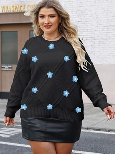 Detail of diamond-quilted knit sweater with blue 3D crochet flowers and long sleeves