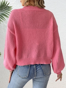 Women's pink long sleeve knit sweater with lantern sleeves and textured chunky knit back