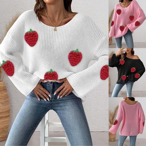 Close-up of knit sweater featuring red 3D crochet strawberries on sleeve and bodice
