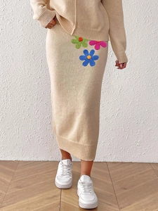 Elegant beige knit two-piece set featuring long-sleeve hoodie and floral embroidered midi skirt