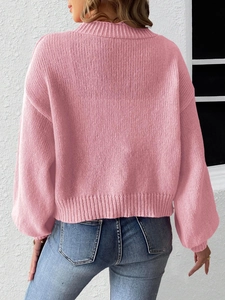 Chic pink loose knit cardigan with lace bow patchwork and ribbed cuffs on back view