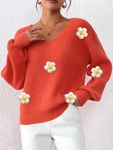 Women's bright orange V-neck knit sweater featuring 3D floral crochet daisy appliques