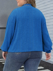 Detail of royal blue ribbed knit texture on a long sleeve plus size mock neck top