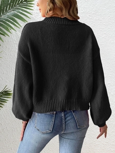 Back view of a black knitted cardigan with fine needlework and ribbed hem on a model
