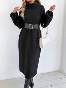 Detail of black knit midi dress showing ribbed texture and high turtleneck design