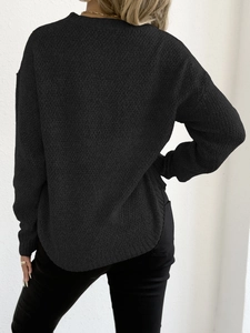 Women's black crew neck sweater with intricate knit texture and a relaxed curved hemline