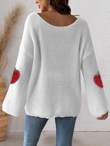 Detail of white knit sweater back featuring red strawberry embroidery on sleeves and loose fit