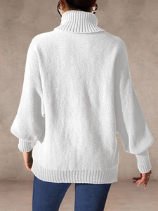 Detailed back view of white turtleneck knit sweater featuring ribbed texture and loose fit