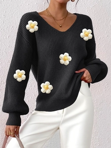 Detail of V-neck knit sweater featuring 3D handmade white floral crochet and puff sleeves