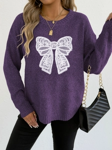 Detail of purple crewneck knit sweater featuring a white lace butterfly pattern
