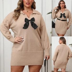 Detail showing oversized black bow and ribbed texture on plus size knit dress