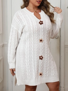 Close-up of white cable knit dress featuring 3D knit flower buttons and V-neck detail