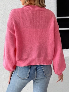 Rear view of pink chunky knit sweater with lace bow patchwork and half-high collar
