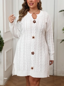 Detail of V-neck white knit dress with crochet floral buttons and cable knit texture