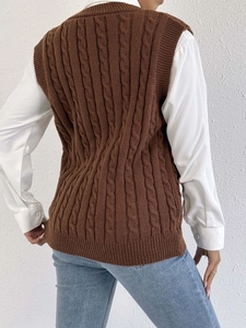 Rear view of a dark brown cable-knit vest showing intricate texture and premium stitching
