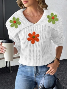 Women white knit sweater featuring large lapel collar and colorful crochet flower embroidery