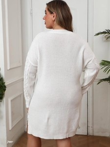 White V-neck knit dress featuring cable knit sleeves and a ribbed hem shown from a back view