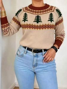Detailed close-up of beige knitted Christmas tree sweater with red geometric patterns