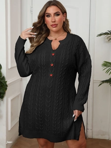 Detail view of black cable-knit dress featuring unique red strawberry decorative buttons