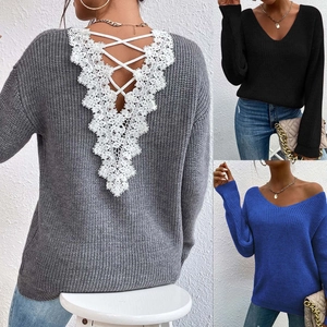 Macro detail of the elegant cross-lace stitching and floral lace V-neck on a knit sweater