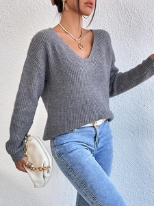Detail of grey V-neck rib-knit sweater with lace stitching and elegant open back