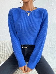 Detailed texture of blue rib-knit sweater featuring a classic round neck and cozy long sleeves