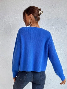 Rear view detail of blue ribbed knit sweater showing loose fit and vertical texture