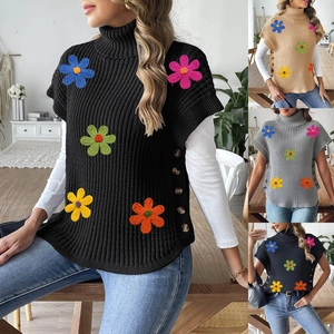 Detail of high-neck knit vest with colorful crochet floral patches and side buttons