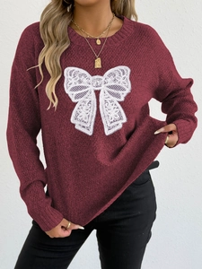 Close-up of wine red knit sweater featuring a decorative white lace butterfly applique