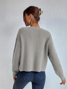 Back view of a grey ribbed knit long sleeve sweater for women with a minimalist fit