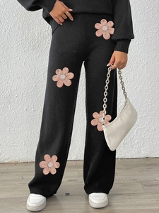 Black knit set for women featuring wide-leg pants with 3D pink flower embroidery