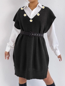 Women's black V-neck knit vest dress with white daisy appliqués and collegiate style