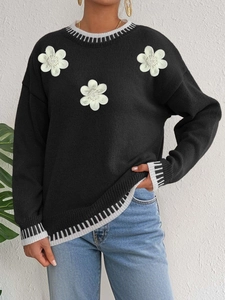Women's black knit sweater with white floral embroidery and striped ribbed trims