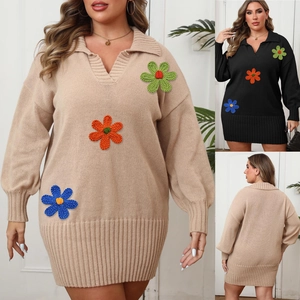 Detailed close-up of long sleeve knit dress with colorful 3D crochet flower patches