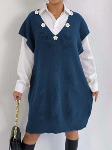 Navy blue V-neck knit vest dress with white hand-crocheted flowers and retro college style