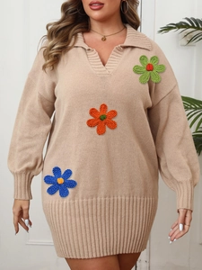 Detail of beige knit polo dress featuring vibrant handmade crochet flower embroidery