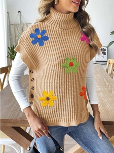 Close-up of knit turtleneck vest featuring colorful crochet flower patches and side buttons