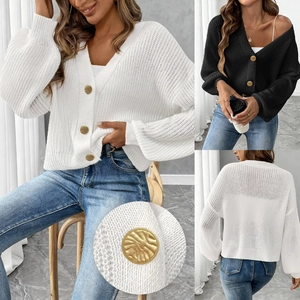 Close-up of vintage golden buttons on a textured knit cardigan sweater for women