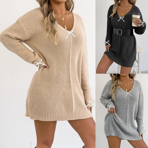Detailed knit texture and delicate white bow accents on a V-neck ribbed mini dress