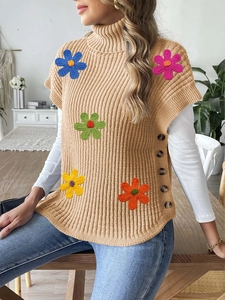Close-up of 3D colorful flower embroidery and button details on knit turtleneck vest
