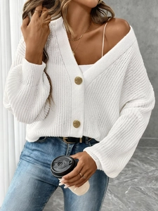 Women's white knit cardigan with textured fabric and prominent gold buttons in a loose fit