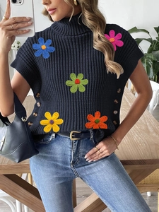 Navy turtleneck knit vest featuring vibrant crochet flower patches and side buttons
