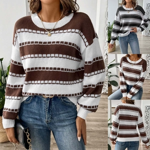 Detail of white ribbed cuffs and hem on the striped round neck knitted sweater