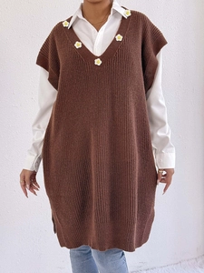 Detail of brown knit V-neck vest with white daisy floral embroidery on the neckline
