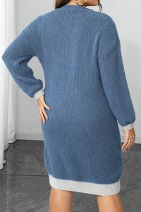 Detail showing the vertical ribbed knit texture and grey contrast cuffs on the blue dress
