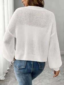 Back view of women's white hollow knit sweater with elegant gold buttons and loose texture