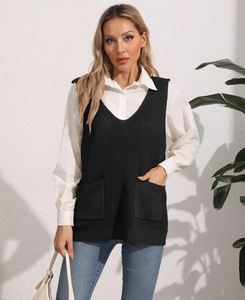 Detail of a black knit V-neck vest with two front pockets paired with a white shirt